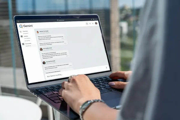 Hands typing on laptop demonstrating AI prompt engineering